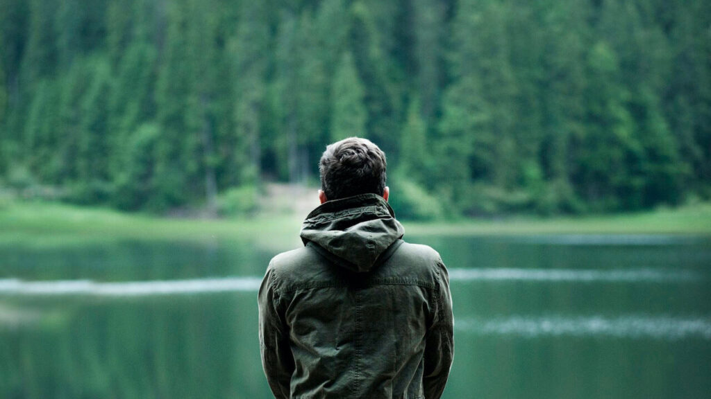 man-relaxing-near-the-lake